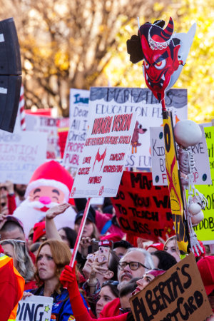 Striking teachers hold signs during a protest at the Alberta Legislature